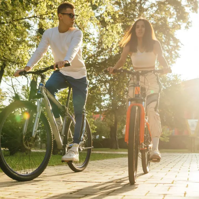 Man and woman cycling together